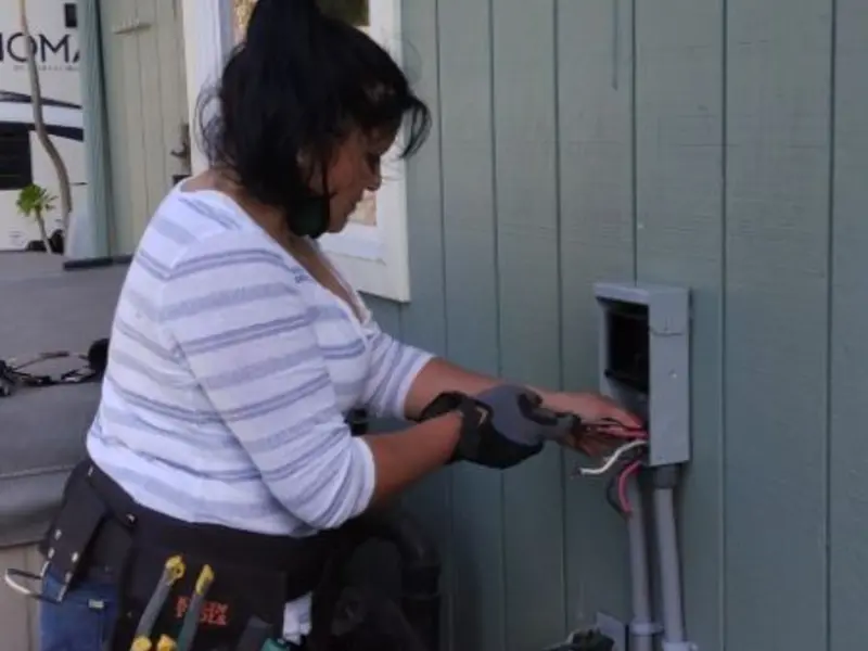 Licensed electrician wiring an exterior subpanel in Iowa Colony